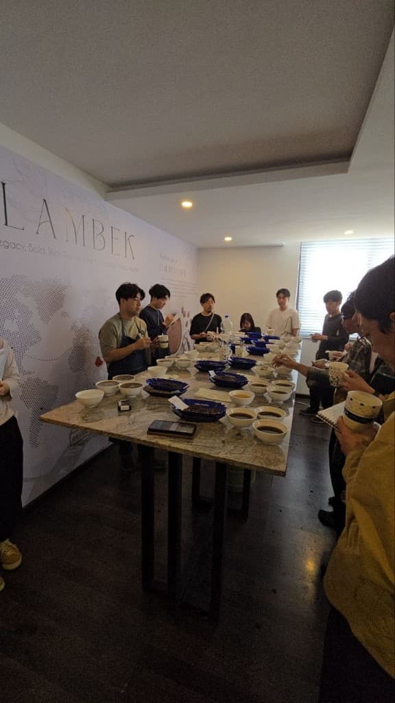 International buyers cupping Lambek Coffee samples in the tasting room
